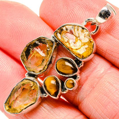 Sterling silver pendant with rough yellow stones and tiger eye drop charm