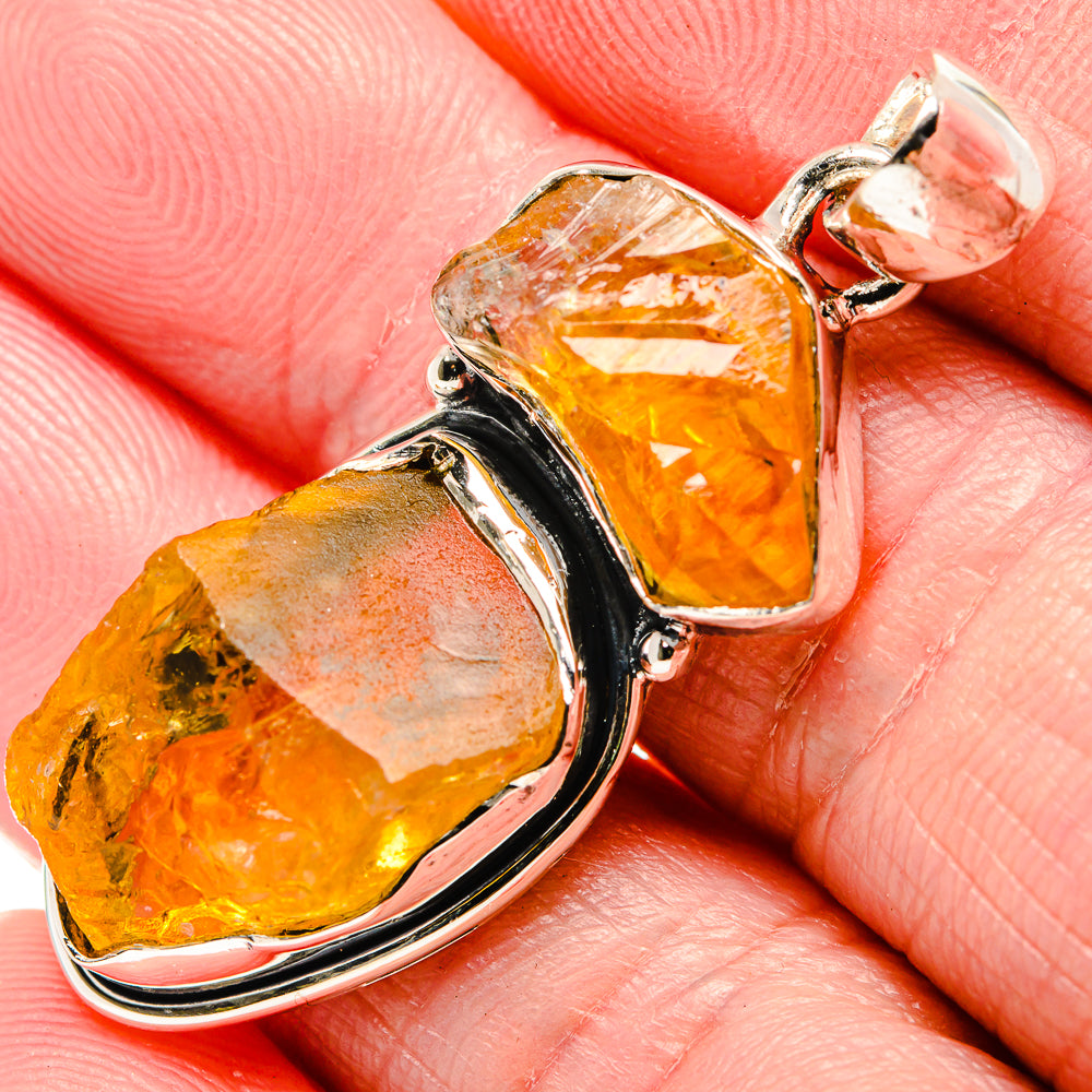 Rough citrine pendant close-up: amber-yellow stones in shiny sterling silver bezel