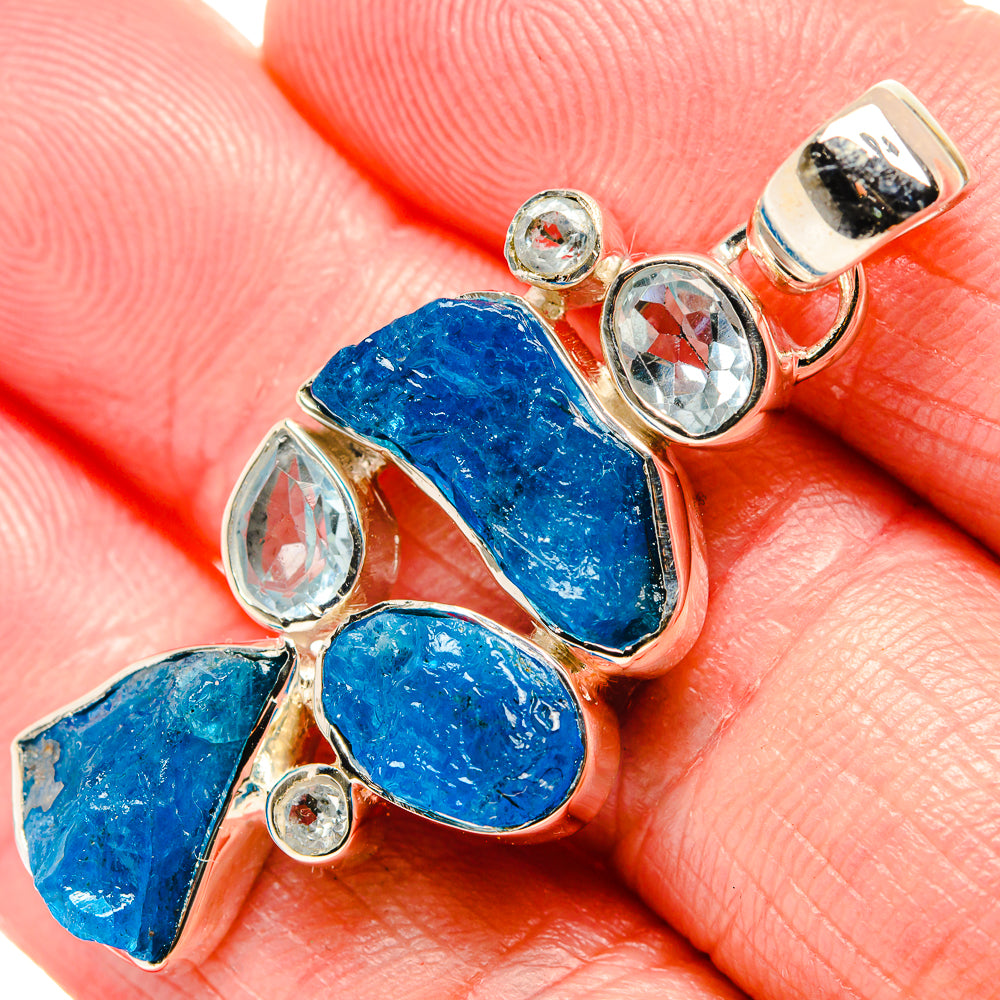 Rough blue stone pendant with clear oval stones and small round gem accents