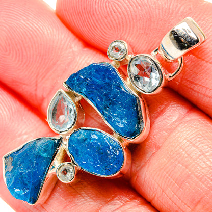 Rough blue stone pendant with clear oval stones and small round gem accents