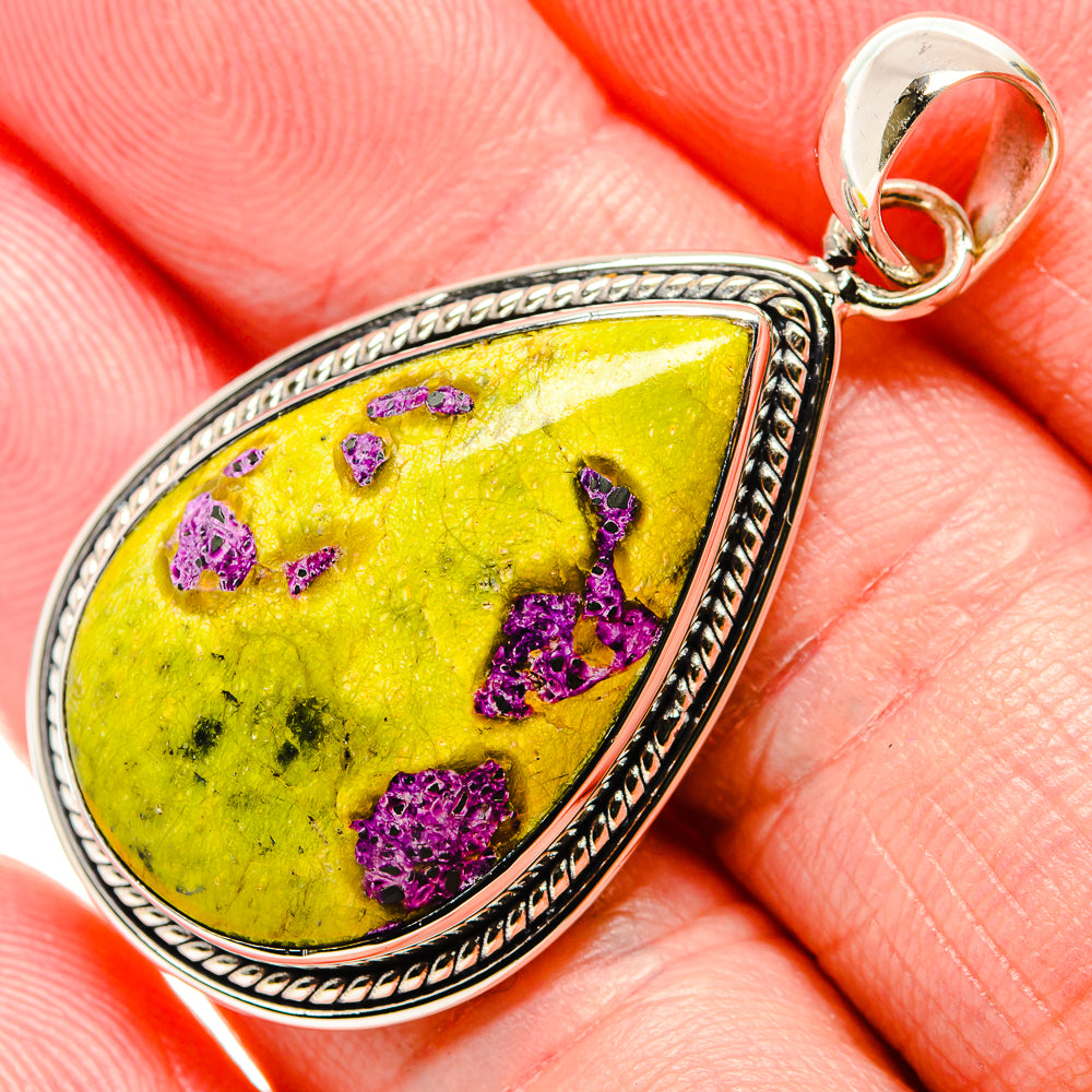 Sterling silver teardrop pendant close-up with lime-green stone and purple druzy
