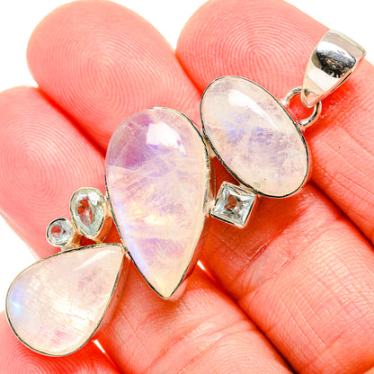 Opal-like teardrop pendant in sterling silver with hanging bail and three stones