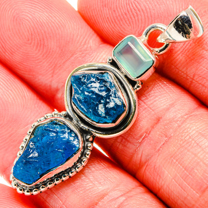 Sterling silver pendant close-up with rough blue stones and pale aqua bar charm