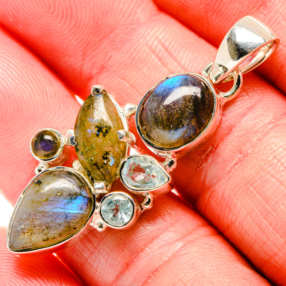 Sterling silver labradorite pendant with blue flashes and small blue topaz accents in settings