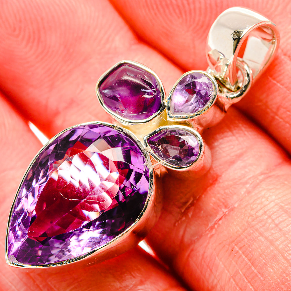 Faceted amethyst teardrop pendant in 925 sterling silver with four small round accent stones