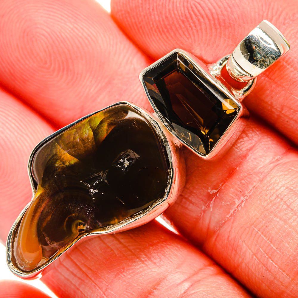 Sterling silver pendant with dark oval gemstone and rectangular smoky-toned stone, green bail