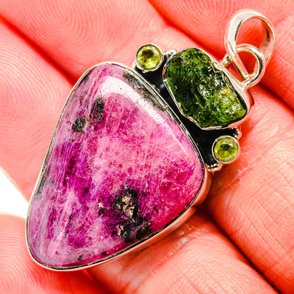Close-up sterling silver pendant with rhodonite teardrop, green peridot and chrome diopside