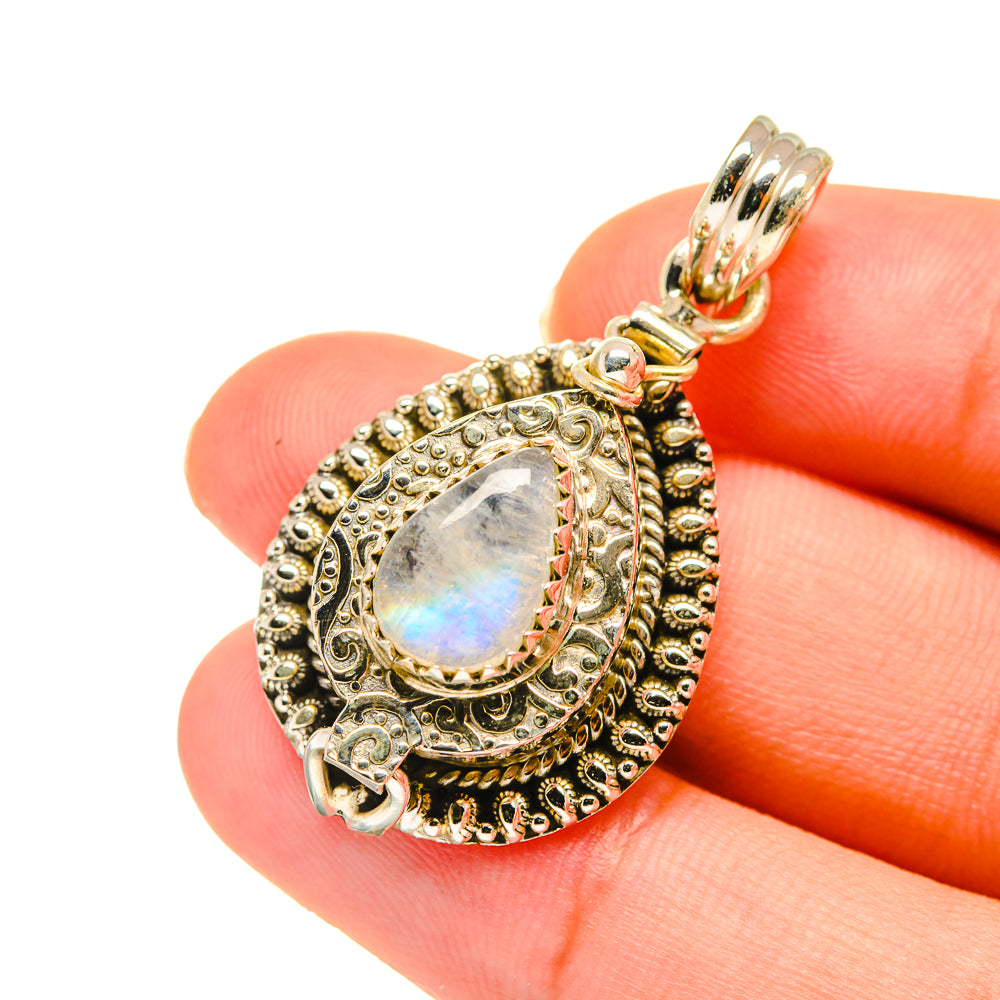 Teardrop moonstone pendant in ornate gold-tone silver setting, with bail and loop