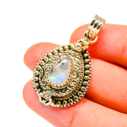 Teardrop moonstone pendant in ornate gold-tone silver setting, with bail and loop