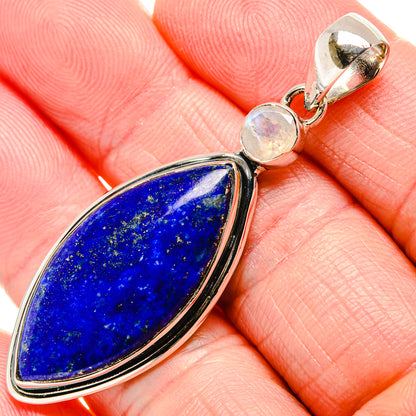 Lapis lazuli teardrop pendant with blue stone, silver bezel, and small round moonstone