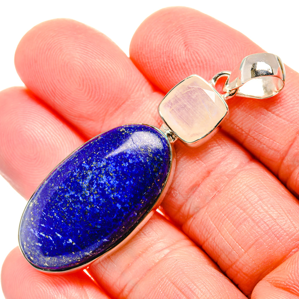 Oval lapis lazuli pendant in silver bezel with square silver and clear stone accents