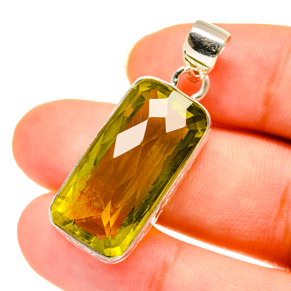 Sterling silver pendant with faceted greenish-yellow quartz, rectangular bezel and hanging bail