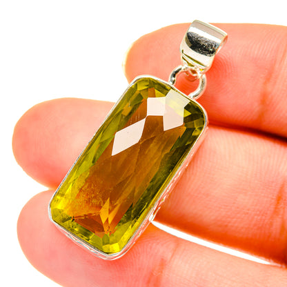 Sterling silver pendant with faceted greenish-yellow quartz, rectangular bezel and hanging bail