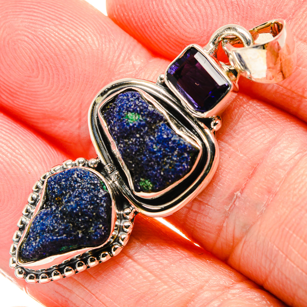 Close-up of 925 sterling silver pendant with rough blue druzy stone and dark purple setting