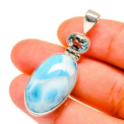 Oval larimar pendant with small blue topaz set in sterling silver bezel