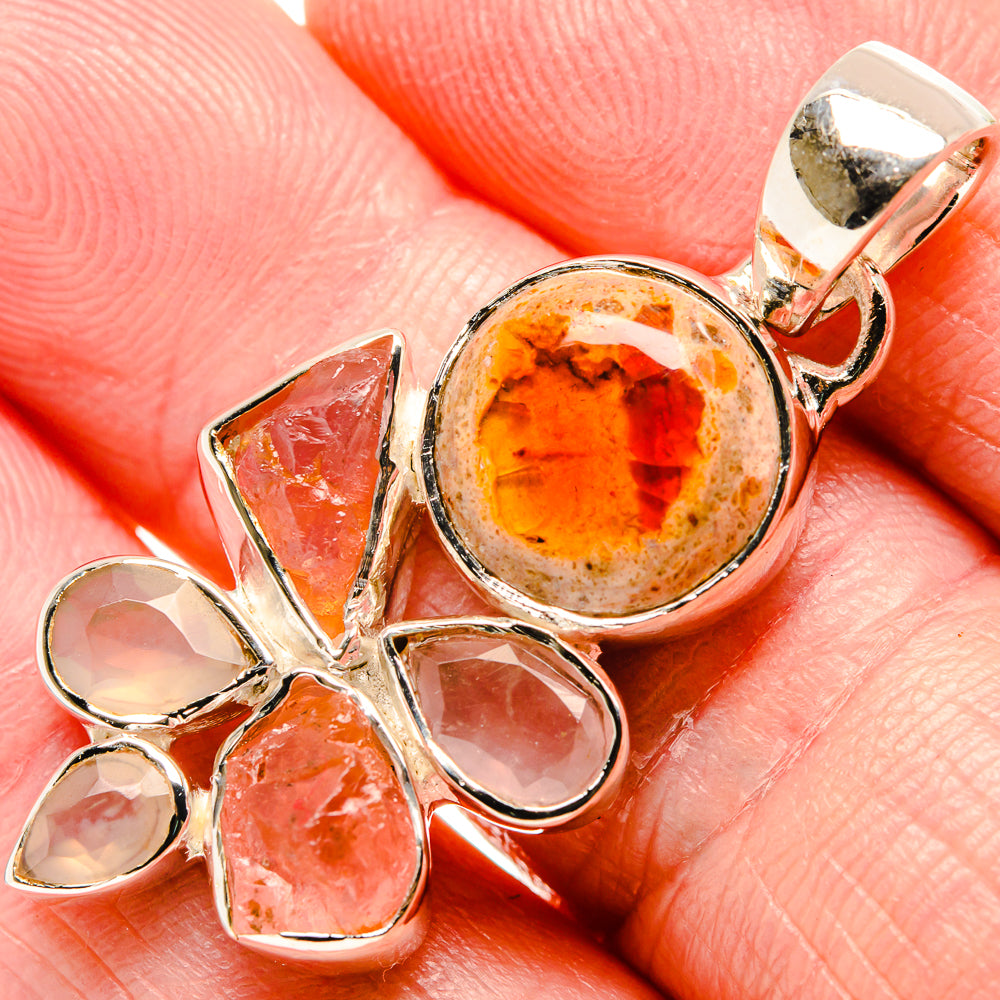 Sterling silver pendant with round orange fire opal center and pink-orange stone cluster