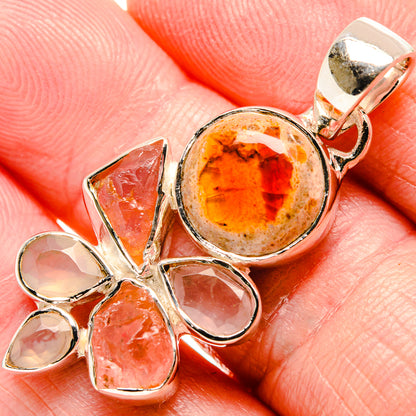 Sterling silver pendant with round orange fire opal center and pink-orange stone cluster