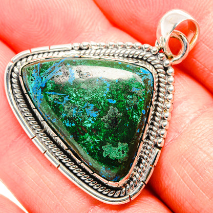 925 sterling silver pendant with triangular green-blue stone and textured rope edging.