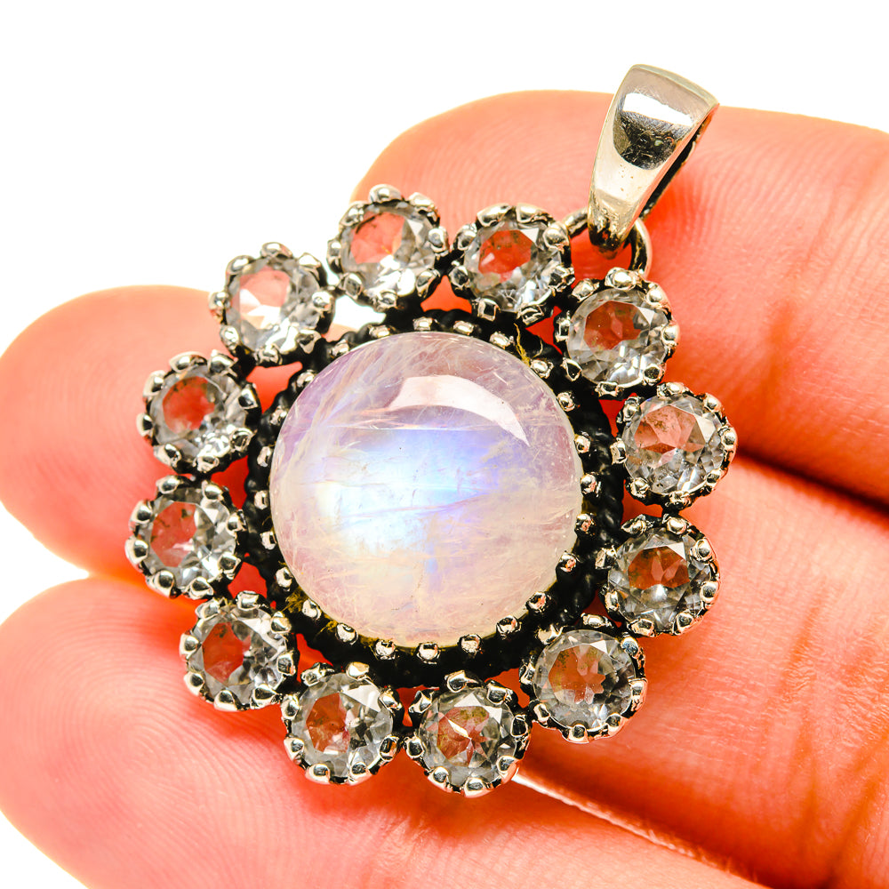 Opalescent round moonstone pendant with orange-red gemstone halo in 925 sterling silver