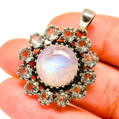 Opalescent round moonstone pendant with orange-red gemstone halo in 925 sterling silver