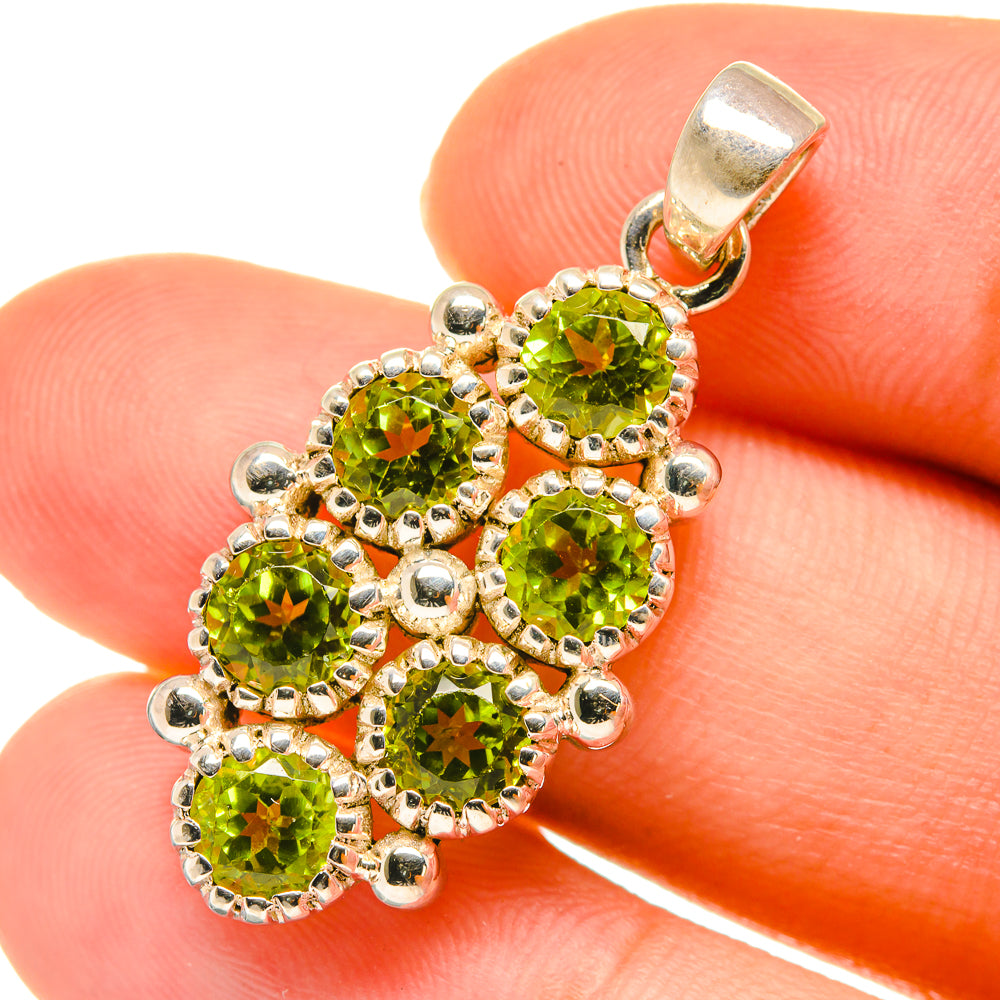 Sterling silver peridot pendant with five green round stones and textured bezel