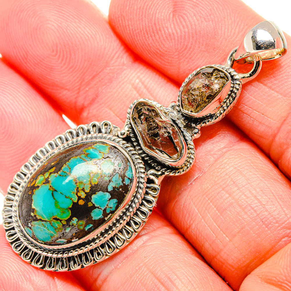 Sterling silver turquoise pendant with two bezel-set oval stones, bail and loop top