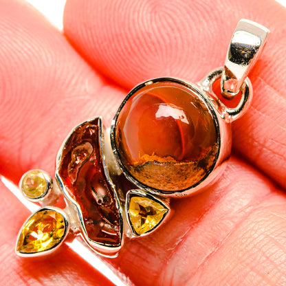 Sterling silver opal pendant close-up, round red-orange cabochon and yellow citrine stones