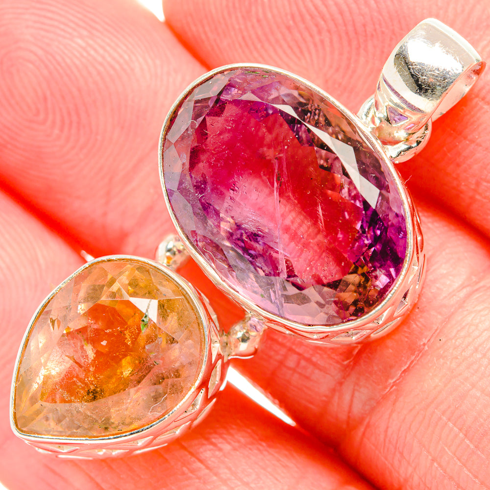 Sterling silver pendant close-up: oval faceted pink ametrine and golden accent stone