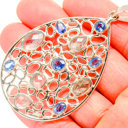 Sterling silver pendant teardrop close-up with blue and clear gemstone cabochons