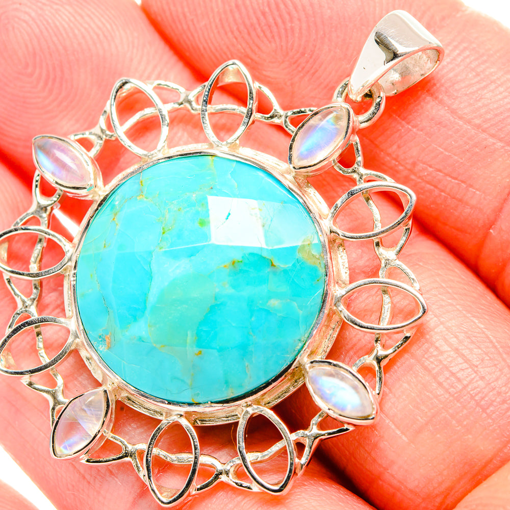 Round turquoise chrysocolla pendant with opal-like bezel stones in silver frame