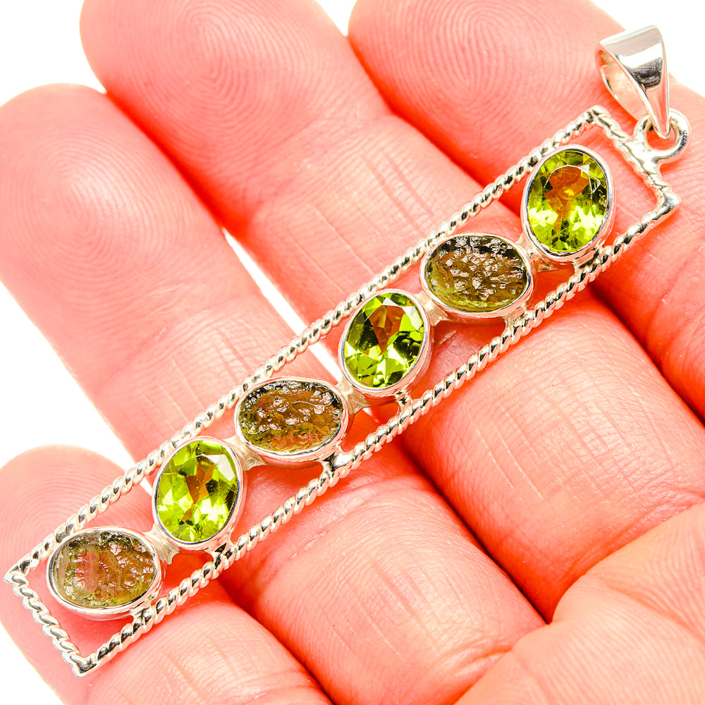 Oval peridot-green gemstone pendant on sterling silver with open bail, close-up