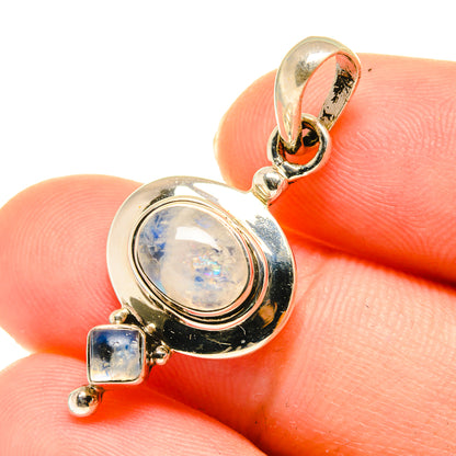 Gold-tone moonstone pendant close-up with oval bezel and square stone drops