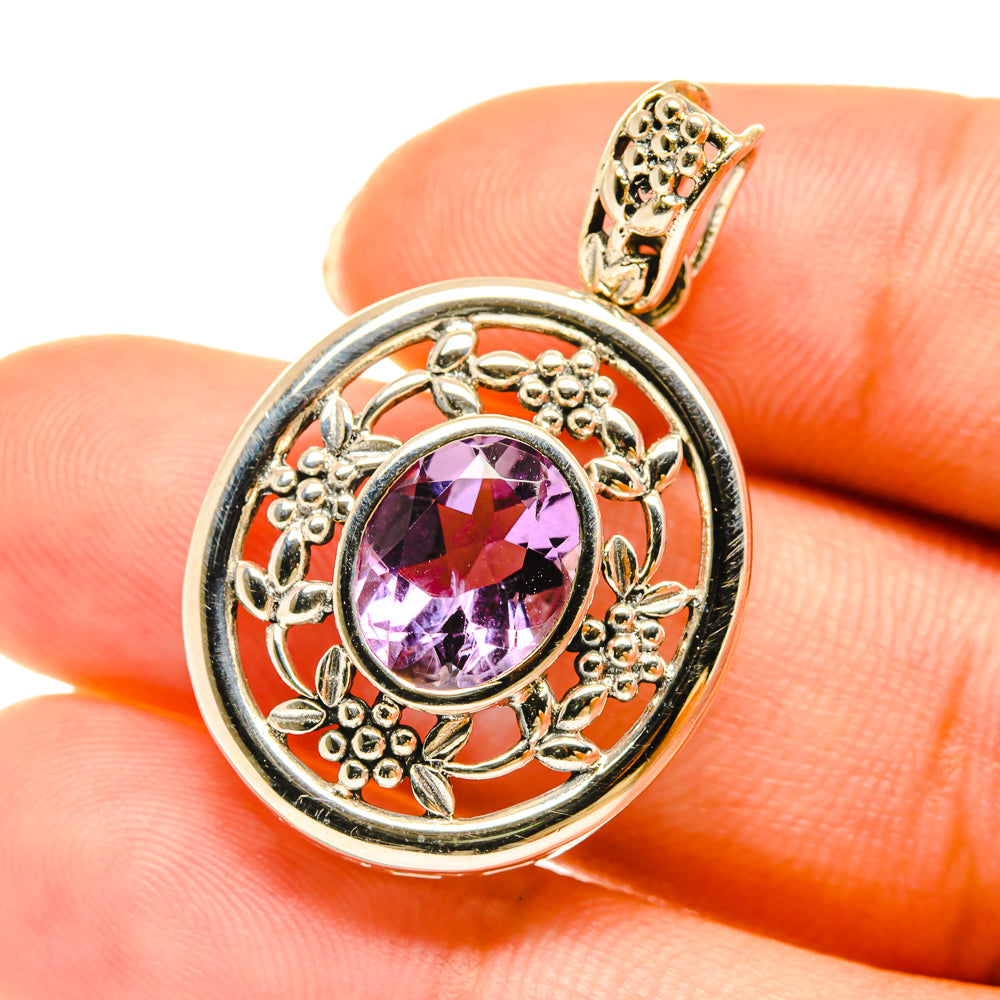 Amethyst pendant close-up in gold-tone 925 sterling silver with faceted purple gem