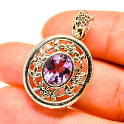 Amethyst pendant close-up in gold-tone 925 sterling silver with faceted purple gem