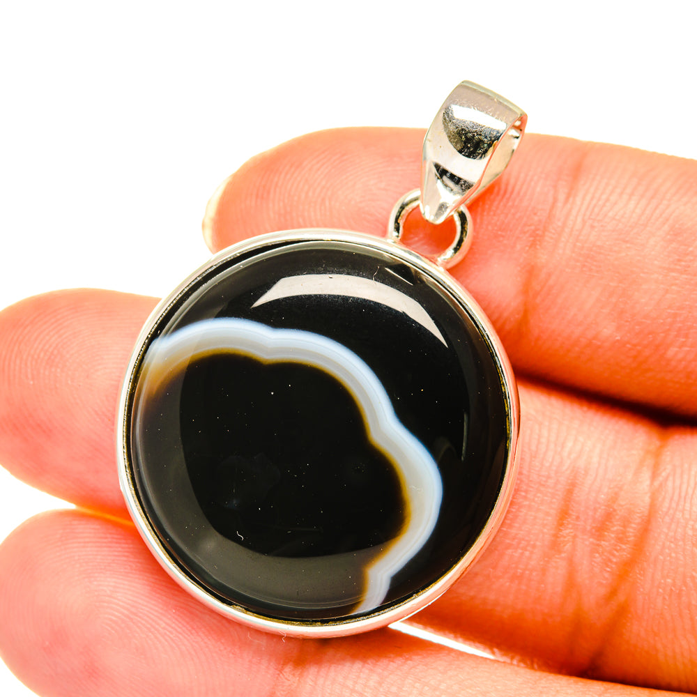 Sterling silver agate pendant with round black stone and white banding, top bail