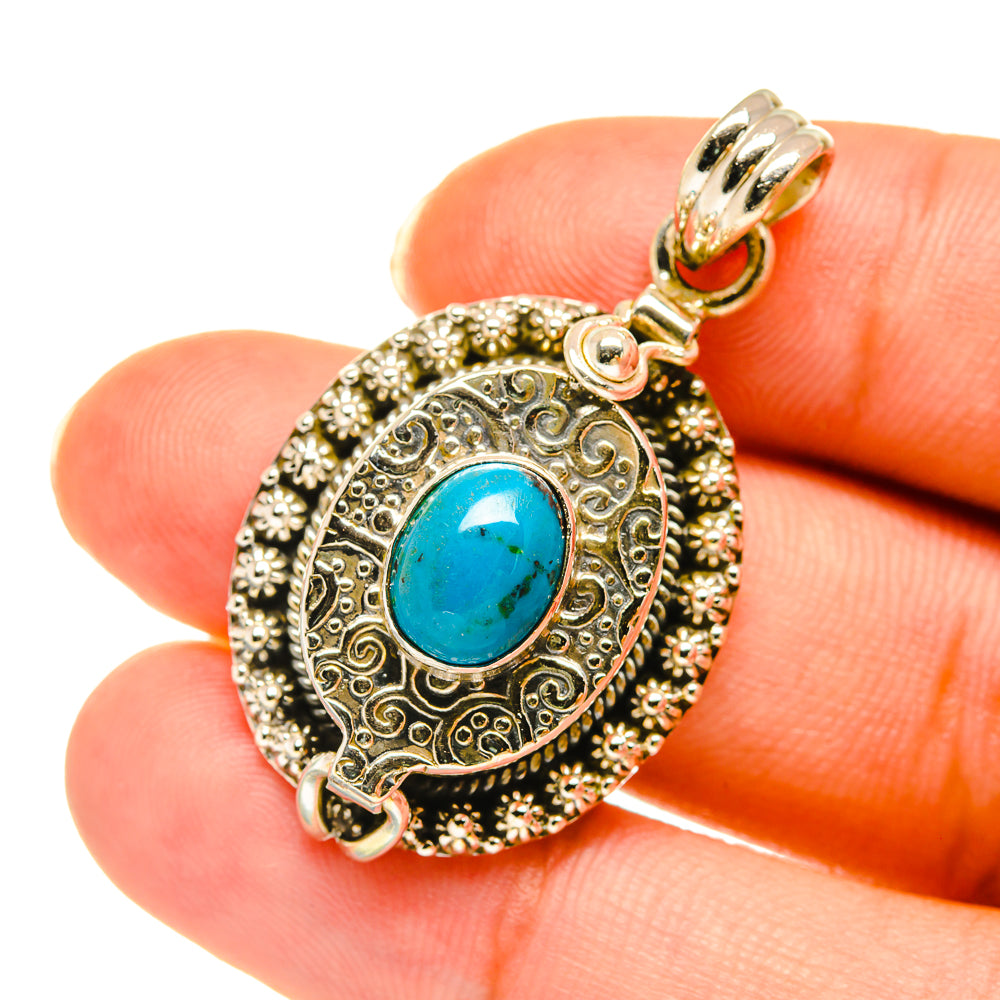 Poison pendant necklace with oval blue gemstone in ornate silver-tone bezel