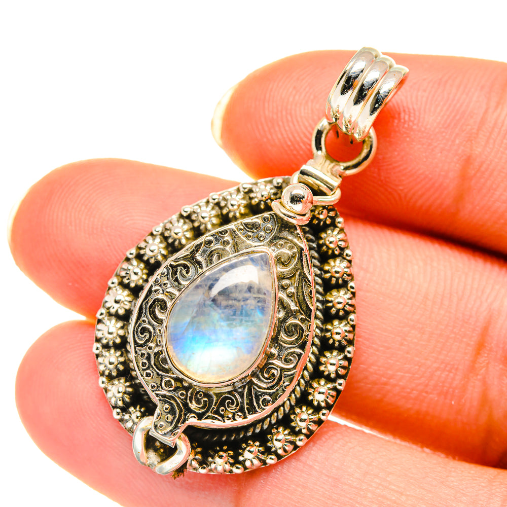 Sterling silver teardrop pendant with iridescent blue moonstone cabochon and filigree