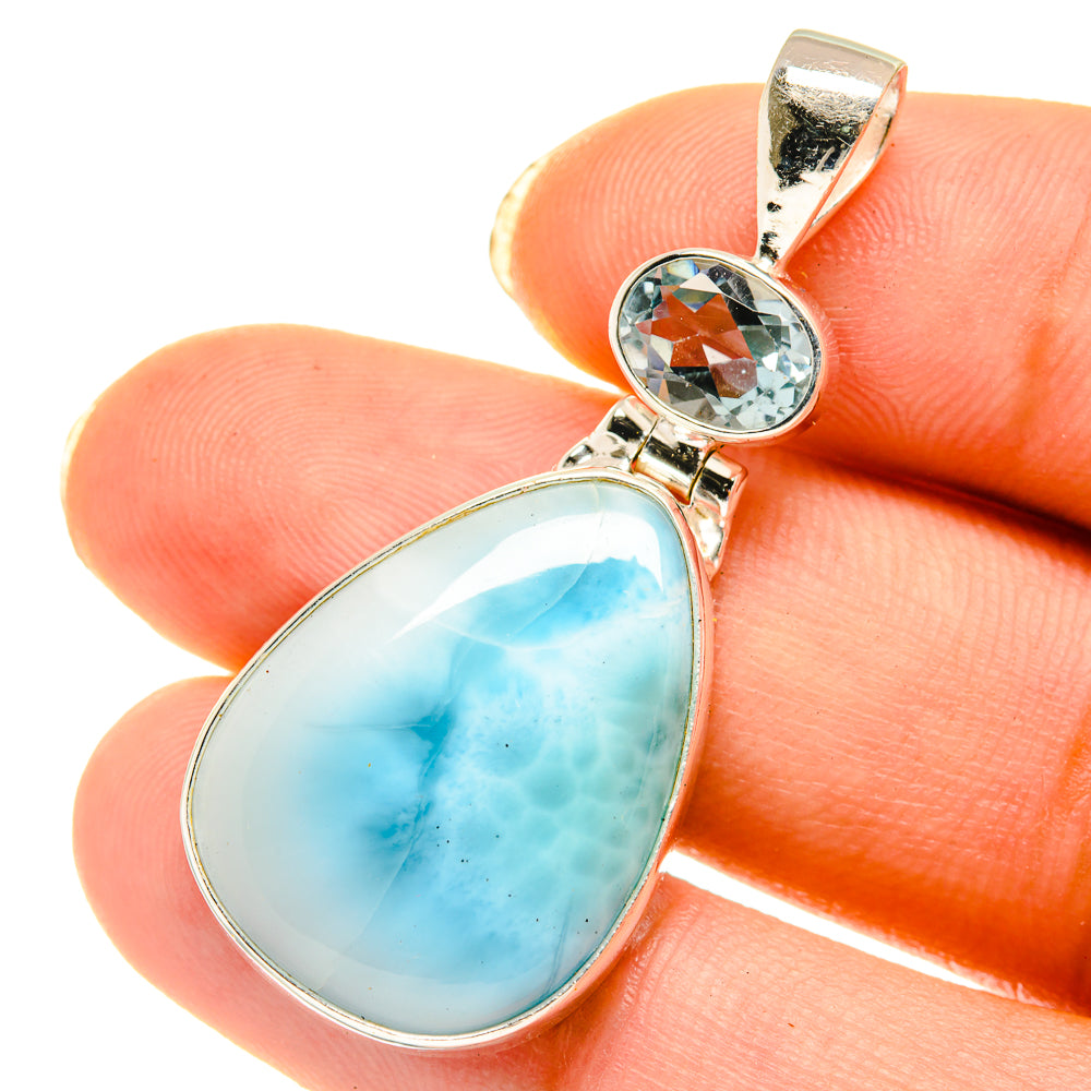 Sterling silver pendant with pear larimar stone and round blue topaz accent