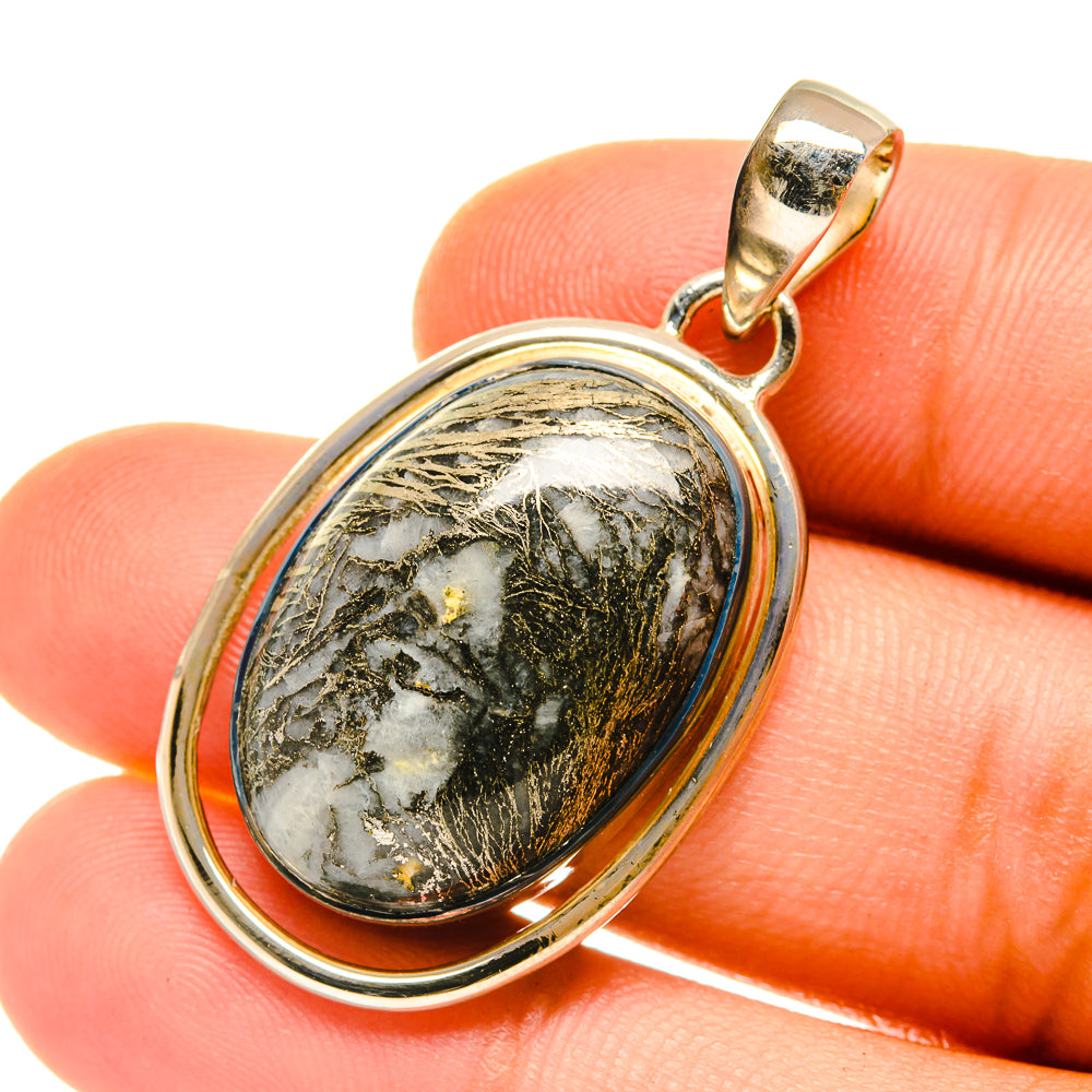 Sterling silver pendant closeup on dark green pyrite agate oval cabochon.