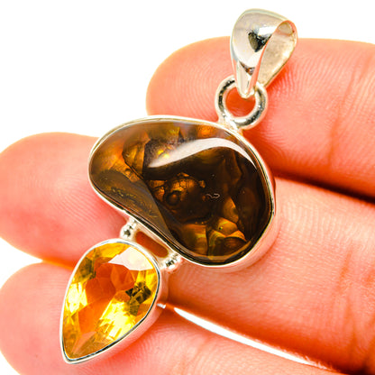 Amber teardrop gemstone pendant with polished silver settings and bail