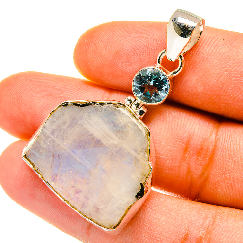 Sterling silver pendant with rough moonstone center and blue topaz round link