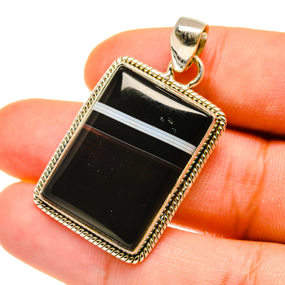 Rectangular black banded agate pendant close-up in ornate 925 sterling silver bezel
