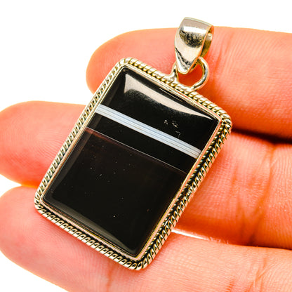 Rectangular black banded agate pendant close-up in ornate 925 sterling silver bezel
