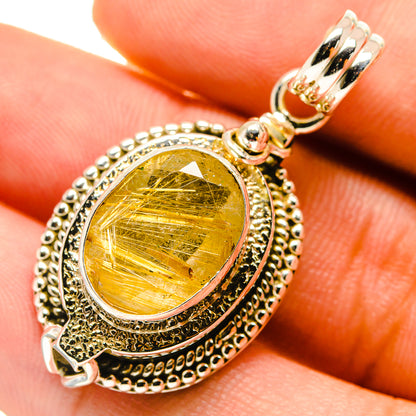 Rutilated quartz pendant close-up with yellow-gold oval stone and silver bead border.