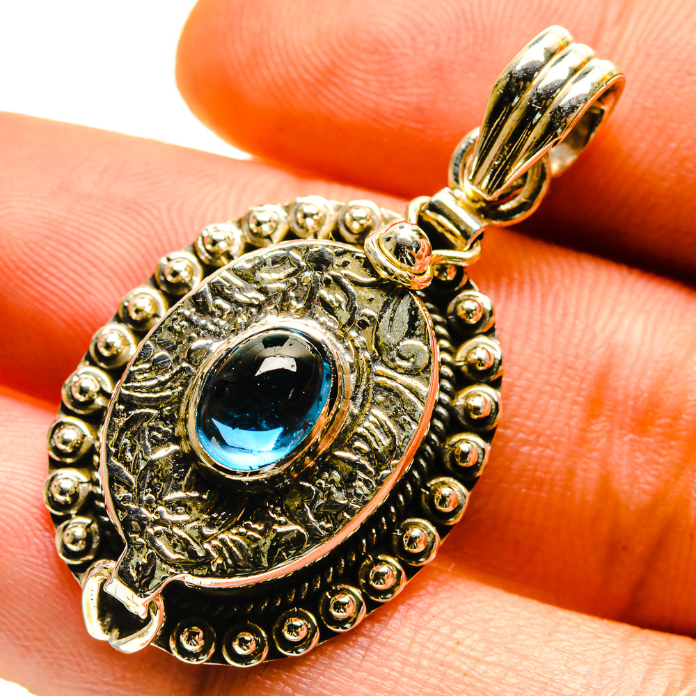 Silver-tone fluorite pendant with oval blue stone and engraved halo setting