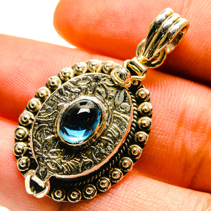 Silver-tone fluorite pendant with oval blue stone and engraved halo setting