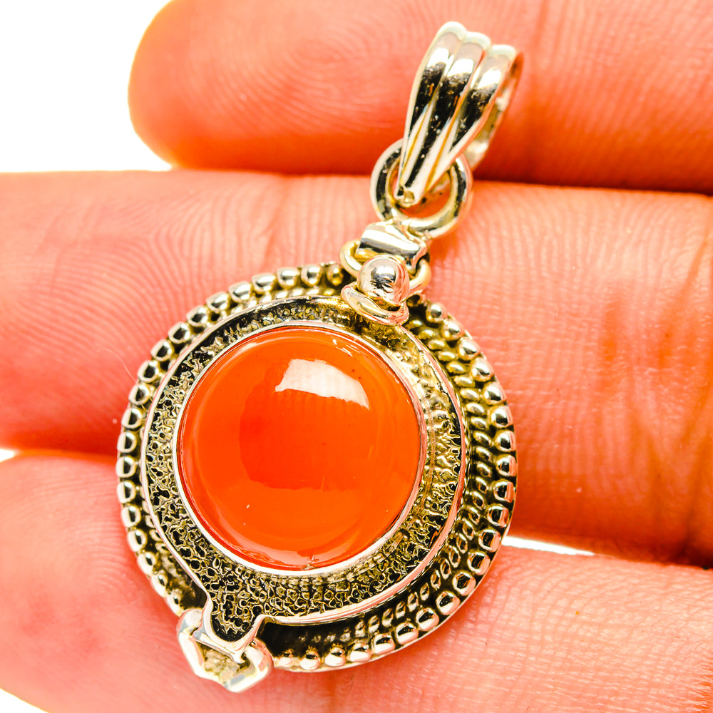 Carnelian pendant with orange round stone and ornate 925 sterling silver bail