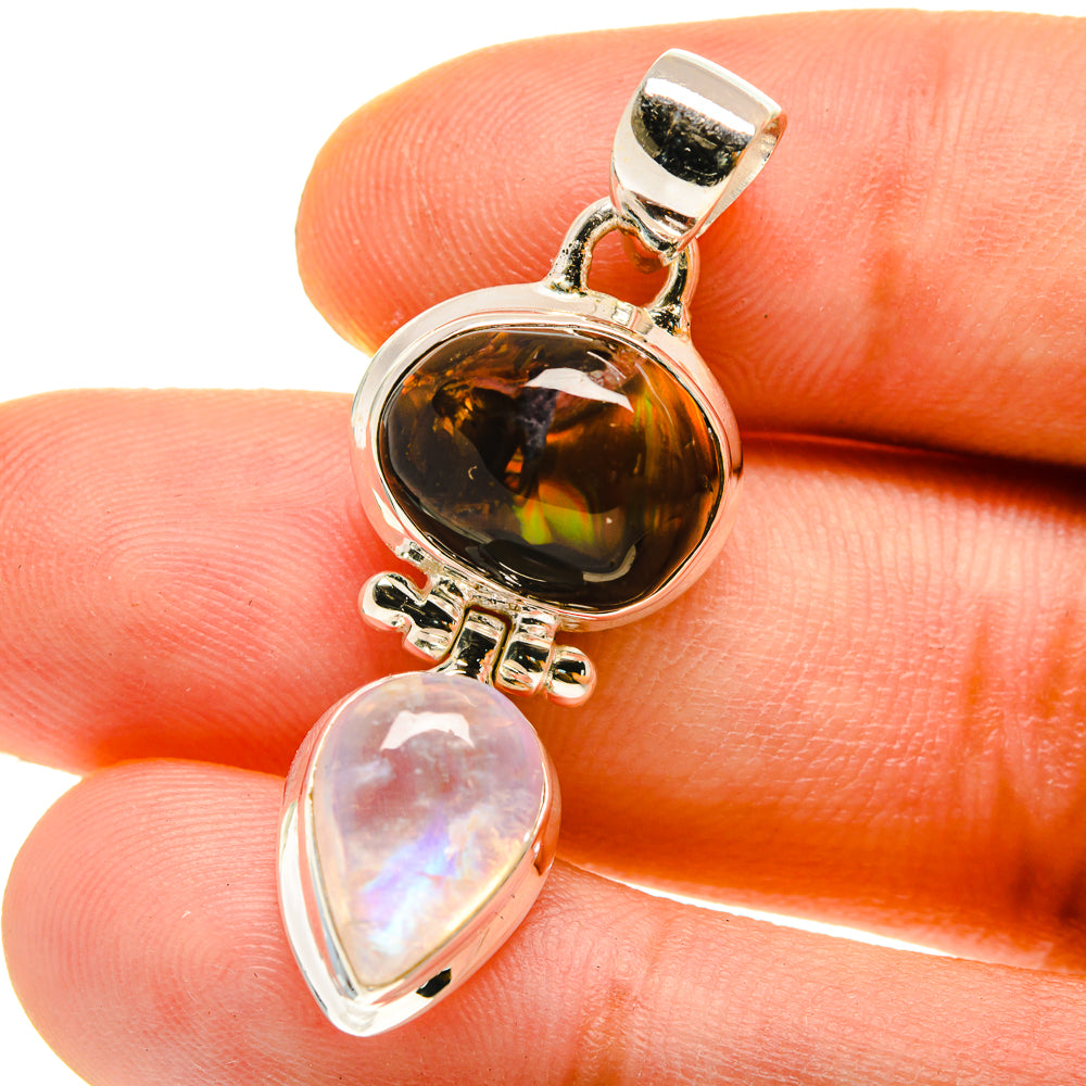 Sterling silver pendant close-up with fire agate cabochon and opal-like moonstone