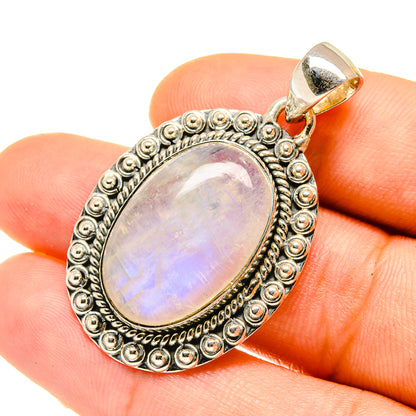 Iridescent oval moonstone pendant in sterling silver with beaded frame and loop bail