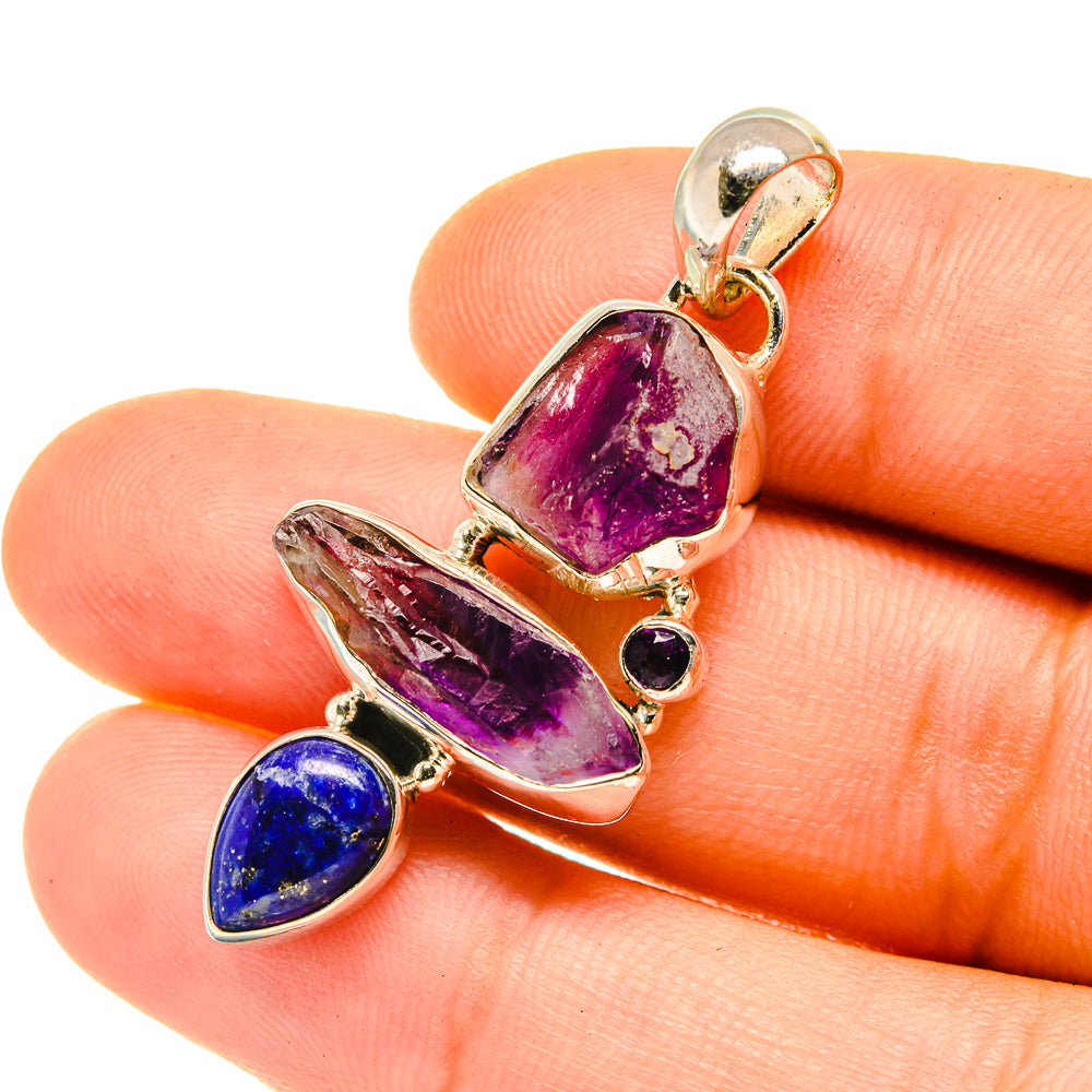 Sterling silver pendant with faceted amethyst center and blue lapis lazuli drop